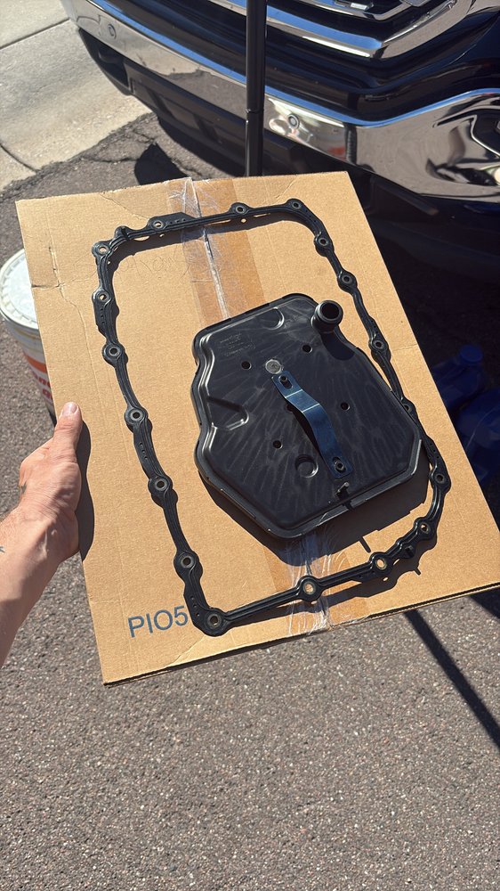 Transmission pan and filter service in a driveway